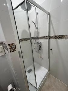 a shower with a glass door in a bathroom at Le Rouet in Marseille +2 photos