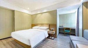 Postel nebo postele na pokoji v ubytování Borrman Hotel Xiamen Xiang'an Maxiang