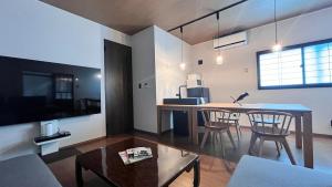 a living room with a table and chairs and a couch at Villa Shunten in Wada +28 photos