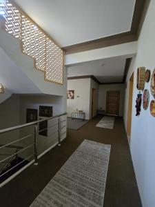 a living room with a staircase and a rug at Rosho Skardu in Skardu