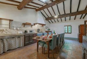 a kitchen with a table and chairs in a room at Tuscan Hamlet In Organic Wine Estate in Buonconvento