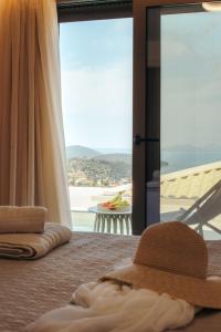 a bedroom with a bed with a view of the ocean at DK Luxury Villas in Sivota +26 photos