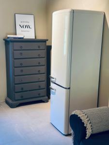 a white refrigerator in a room with a dresser at Le Porrine III in Niederdorla +25 photos
