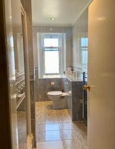 a bathroom with a toilet and a window at 4 Friends House in Edinburgh +14 photos