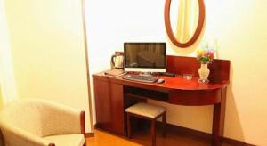 a desk with a computer on it with a chair at GreenTree Inn JiangSu DingShu Twon JieFang(E) Road Express Hotel in Zhoushu +47 photos