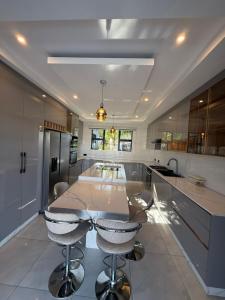 een keuken met een tafel en stoelen erin bij Davisons Guest House in Harare