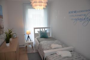 Łóżko lub łóżka w pokoju w obiekcie Equilibrium Apartments