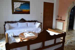 a bedroom with a bed with a table on it at Live The Dream in Naxos Chora