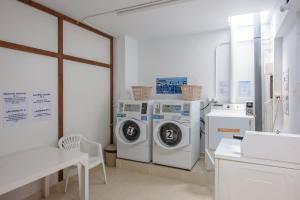 a laundry room with two washing machines and a table at Casita Villacana in Estepona
