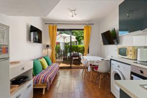 a kitchen and living room with a couch and a table at Casita Villacana in Estepona