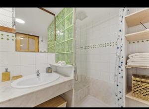 a white bathroom with a sink and a shower at Vista a Fermina in Arrecife +9 photos