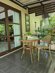 a dining room with a table and chairs at Bang Po Hut in Ban Bang Po