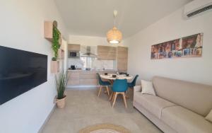 a living room with a couch and a table at Le case del Borgo - Marzamemi in Marzamemi