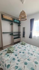 a bedroom with a bed with a floral bedspread at Le case del Borgo - Marzamemi in Marzamemi +13 photos