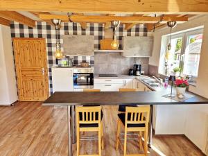 a kitchen with a large island in the middle at Ferienhaus Meeresrauschen am Salzhaff - ABC582 in Boiensdorf