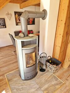 a kitchen with a woodburning stove in a room at Ferienhaus Meeresrauschen am Salzhaff - ABC582 in Boiensdorf