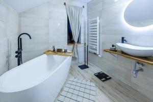 a white bathroom with a tub and a sink at Abran Edelweiss in Tohanu Nou +25 photos