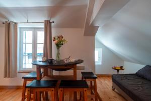 a living room with a table with a vase of flowers on it at Le Burton - Joli T3 centre de Vannes in Vannes