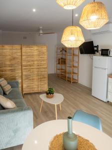 a living room with a couch and a table at Boho Beach Flats in Valencia