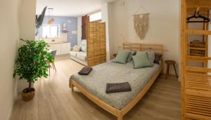 a bedroom with a bed and a living room at Boho Beach Flats in Valencia
