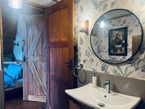 a bathroom with a sink and a mirror at Rustique Lodge in Nuwara Eliya