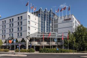 a large building with flags in front of it at Scandic Jyväskylä Station in Jyväskylä