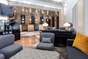 a lobby with chairs and a desk and a salon at Scandic Jyväskylä Station in Jyväskylä