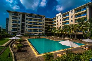a swimming pool in front of a building at Sakura Residence & Hotel in Yangon