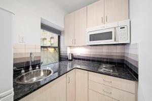 a kitchen with a sink and a microwave at Corporate Style Studio Near State House in Boston +3 photos