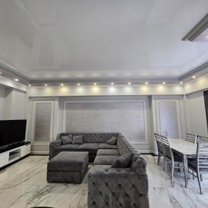 a living room with a couch and a table at Malibu park lux escape in Yerevan +11 photos