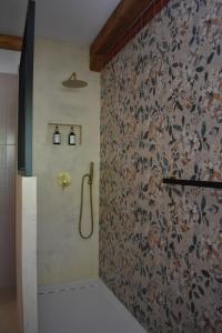 a bathroom with a shower with a floral wallpaper at 2 or 4-person apartment CasaDaEfde in Cingoli
