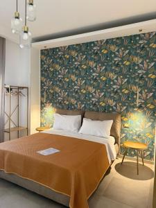 a bedroom with a large bed with a floral wallpaper at Flower rooms Palermo in Palermo