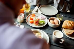 a table with plates of food and eggs and bread at Bretterbude Büsum in Büsum