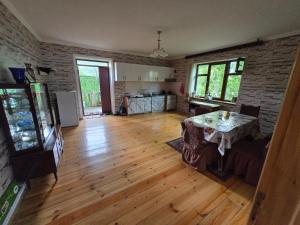 a living room with a table and a brick wall at Heaven apartment in Gabala +9 photos