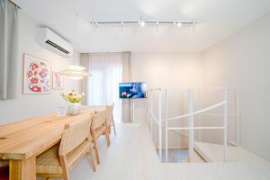 a dining room with a wooden table and chairs at Ken's Place Azabu-Juban in Tokyo +39 photos