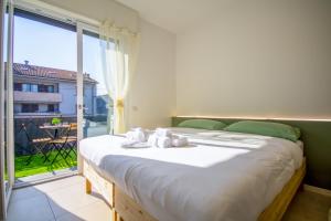 a bedroom with a large bed and a large window at Il capolinea - Ippodromo in Bareggio