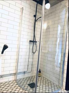a shower in a bathroom with a tile wall at Han Sylte Bed and Breakfast in Fauske +41 photos