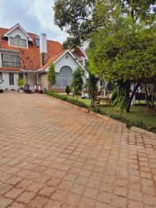 a brick road in front of a house at Teresita Home JKIA in Nairobi