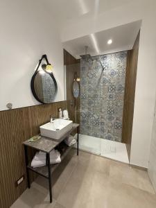 a bathroom with a sink and a shower at Flower rooms Palermo in Palermo