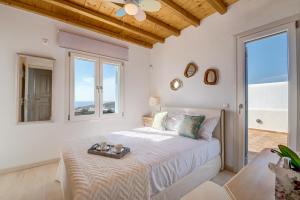 a bedroom with a bed with a tray on it at Paradisia Villas in Tourlos +124 photos