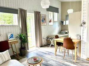 a kitchen and living room with a table and chairs at Lilla huset Bed & Breakfast - countryside guesthouse, free parking in Örebro