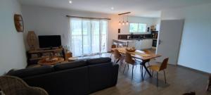 a living room with a couch and a table at Agapanthe location in San-Nicolao