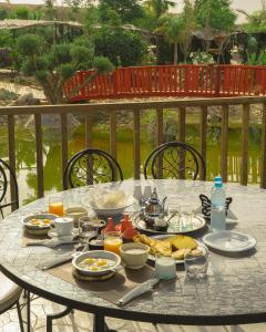 a table with food and drinks on top of it at The Ranch Resort in Marrakech