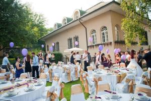 Un groupe de personnes debout autour de tables devant un bâtiment dans l'établissement Villa Székely, à Leányfalu