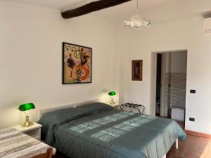 a bedroom with a bed and a chandelier at MUSEO GAR-Hotel in Certosa di Pavia