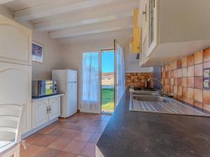 a kitchen with a sink and a refrigerator at Maison 3 chambres avec jardin, proche plage et centre, Biscarrosse-Plage - FR-1-521-35 in Biscarrosse-Plage