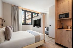 una habitación de hotel con una cama y un televisor en Dobo Madrid Betanzos, en Madrid