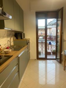 a kitchen with a sink and a door to a patio at La Casa al Mare in Rapallo +8 photos
