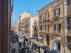 einen Balkon mit Blick auf eine Straße mit Gebäuden in der Unterkunft Al Donà in Bari