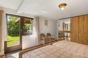 a bedroom with a bed and a window and a table at Ferienwohnungen Demberg in Schmallenberg